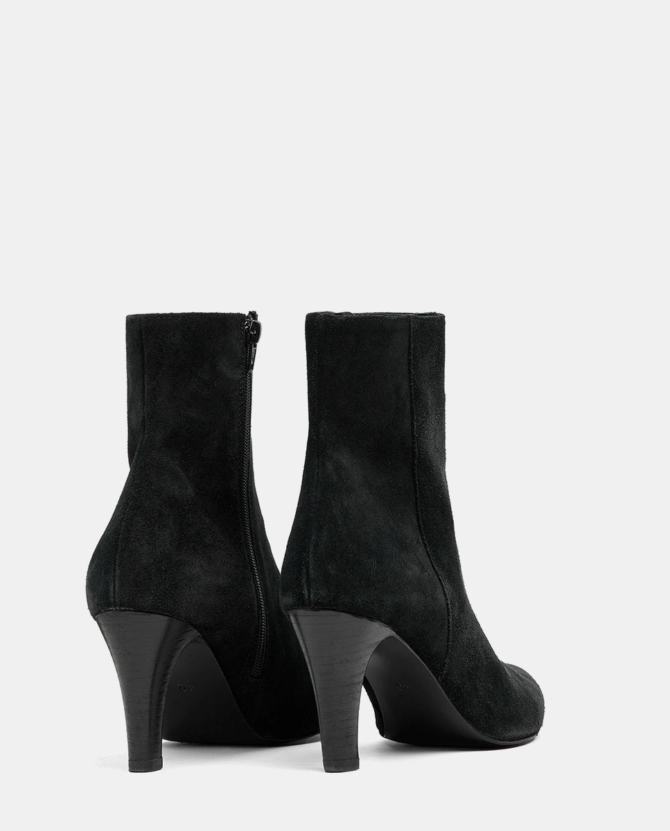 botines negros ante mujer